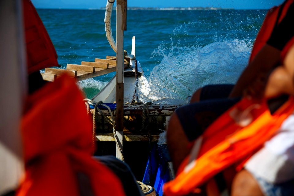 Person Riding A Boat Wearing Life Vest