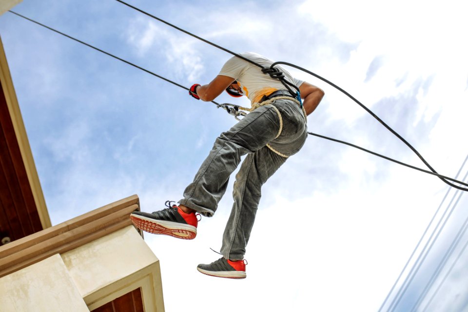 Man Wearing Harness Going Down Building
