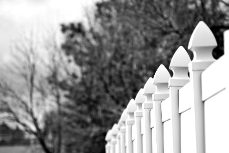 Gray Scale Photo Of White Fence photo