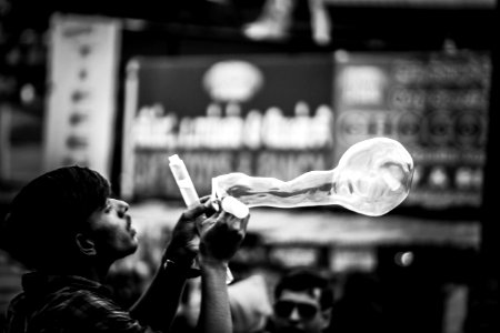 Man Playing Bubbles Grayscale Photo photo