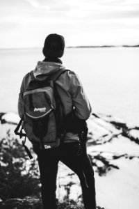 Grayscale Photo Of Man Wearing Windsor And Backpack photo