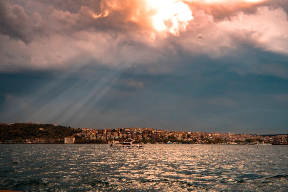 Concrete Buildings Near Sea Under White And Blue Cloudy Sky