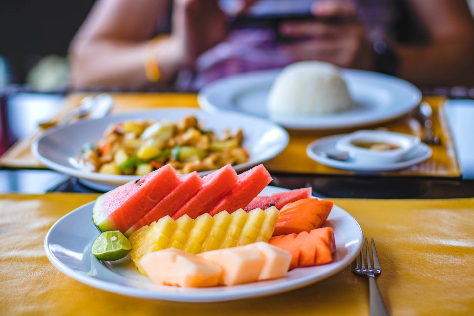 Round Ceramic Plate Filled With Sliced Watermelon Pineapple And Carrots