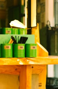 Six Green Tin Can Containers On Table photo