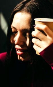 Woman Wearing Red Long-sleeved Shirt Holding Cup photo