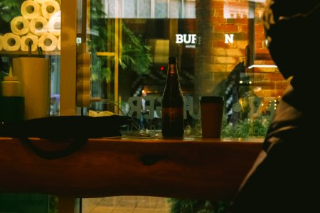 Beer Bottle Beside Solo Cup On Table