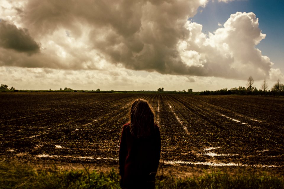 Womens Red Sweat Shirt Standing In The Middle Of The Field