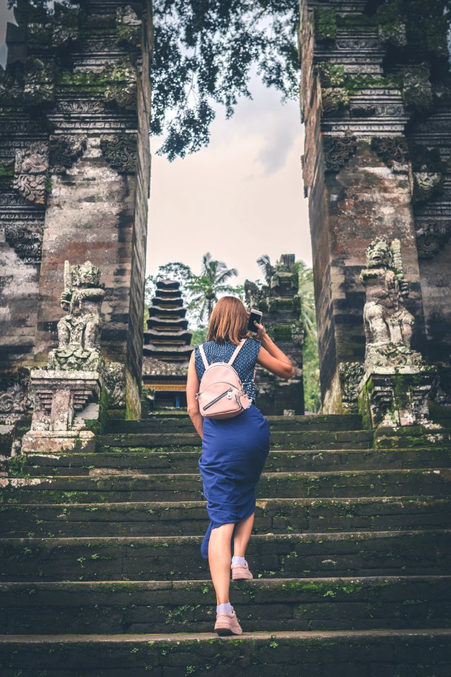 Woman In Blue Dress Walking On Concrete Staircase Leading To Buildings photo