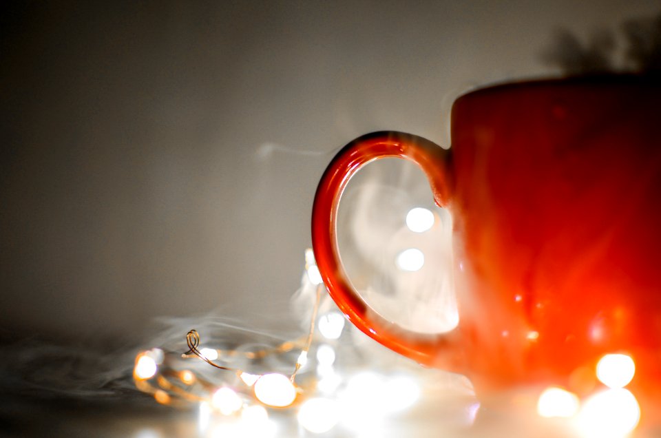 Red Mug Beside String Lights