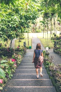 Woman In Blue And Red Dress Walking Down The Stairs photo