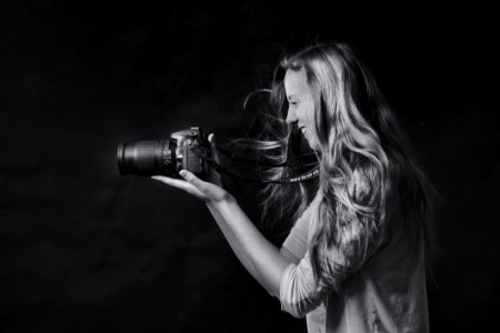 Grayscale Photo Of Woman Using Dslr Camera photo