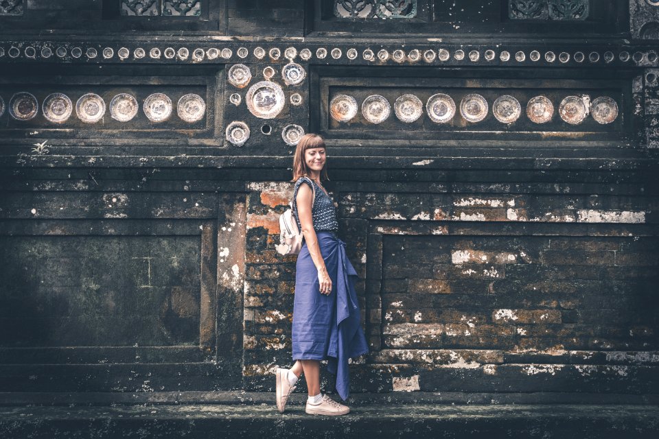Womens Blue Sleeveless Shirt Near Gray Concrete Wall