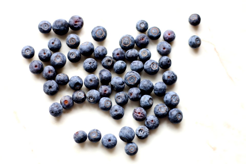Photo Of Black Berries On White Surface