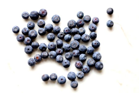 Photo Of Black Berries On White Surface