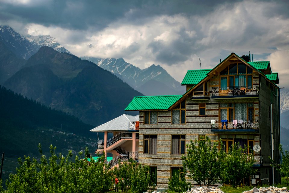 Brown And Green Concrete Building Near Mountains At Daytime photo