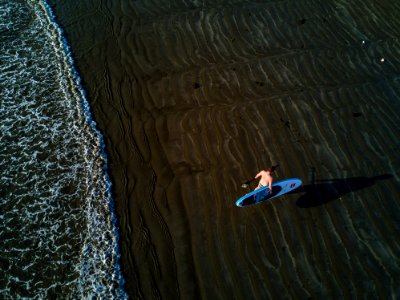 Person Holding Surfboard Near Seashore photo