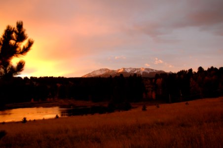 Silhouette Photo Of Grass Field With Body Of Water And Mountains