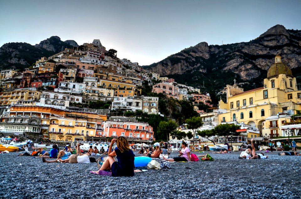 Woman Sitting On Gray Soil Near Houses