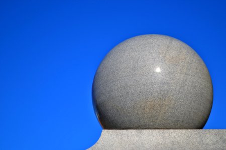Gray Ball On Gray Surface With Blue Background photo