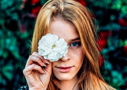 Shallow Focus Photography Of Woman Holding White Flower photo