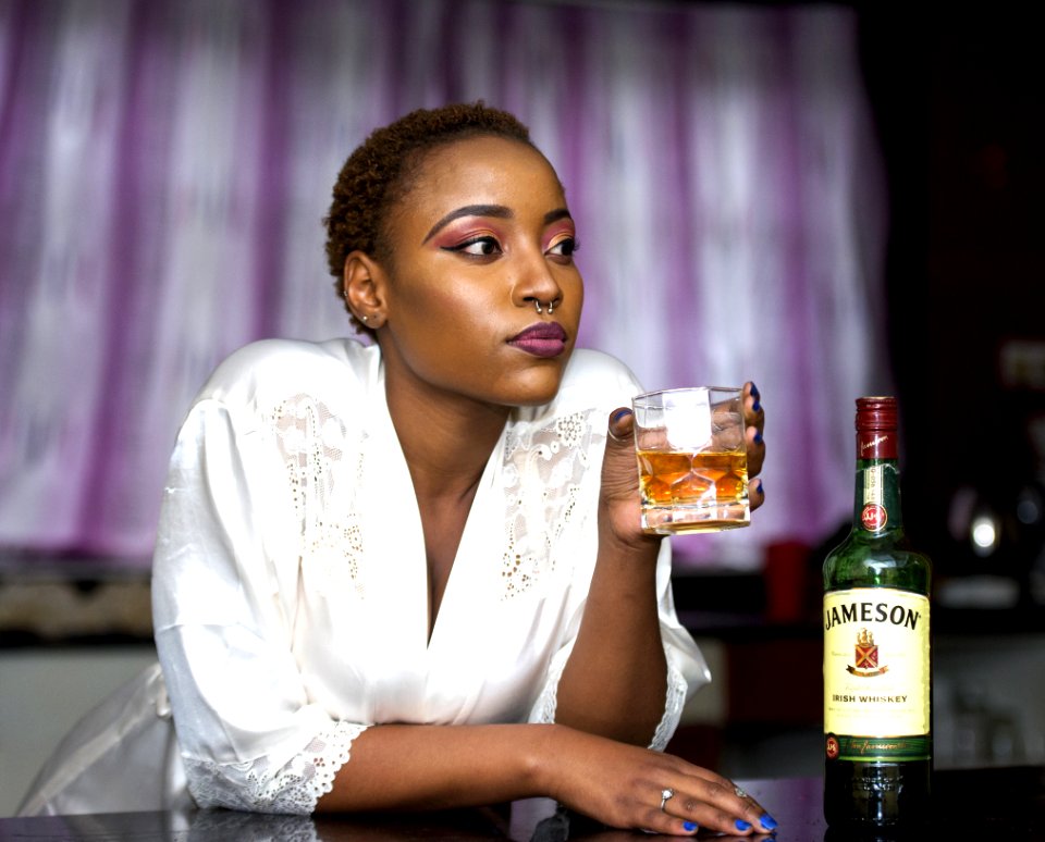 Woman Wears White Lace Bathrobe Holds Shot Glass