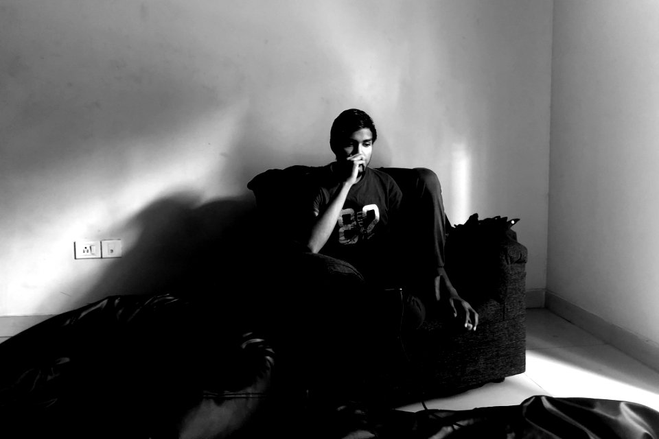 Man Wearing Black Pants On Armchair