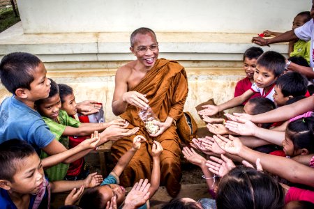 Man In Monk Dress Between Group Of Children photo