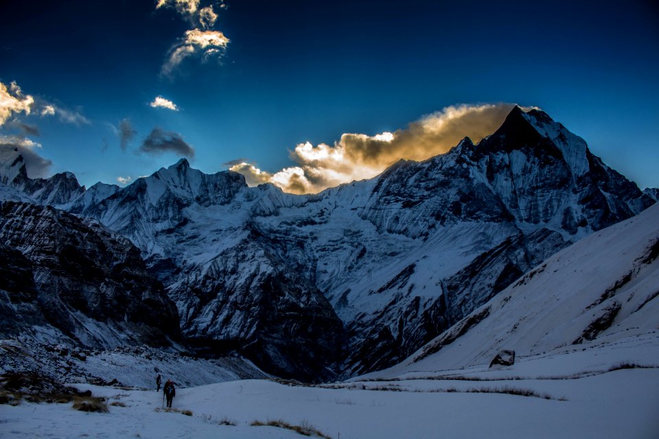 Person Walking In Snow Mountain