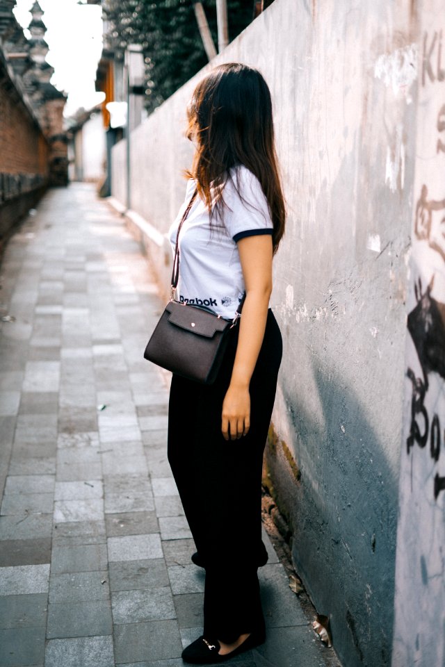 Woman Wearing Black And White T-shirt And Black Pants