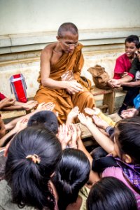 Monk Handing Towards Kids