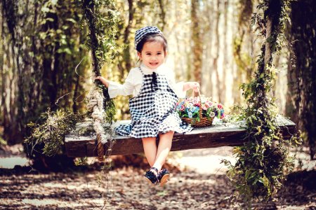 Girl In Black And White Overall Skirt Holding Basket With Petaled Flowers