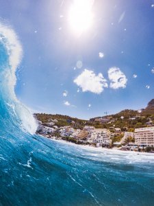 Closeup Photography Of Sea Wave Near Concrete Building At Daytime photo