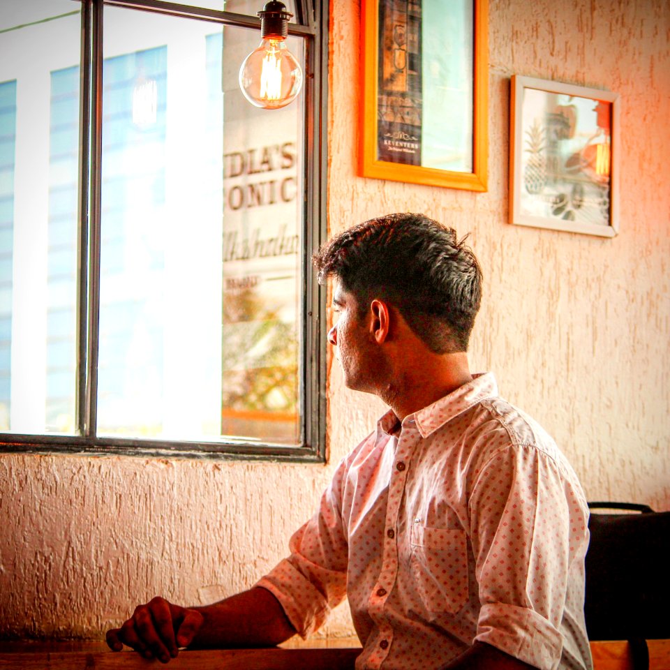 Man Wearing White And Red Dress Shirt Staring Outside Window photo