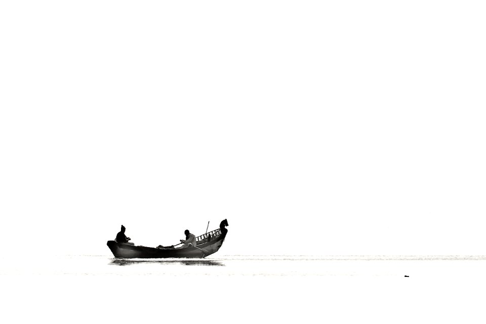 Two Person Riding Boat On Body Of Water