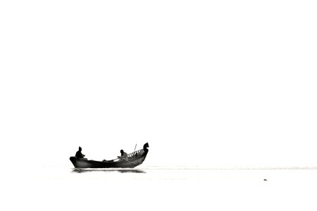 Two Person Riding Boat On Body Of Water photo
