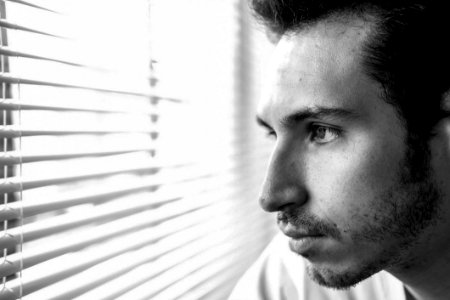Man Looking Through Window