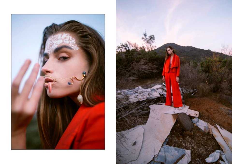 Woman In Red Jumpsuit Standing On Gray Rock