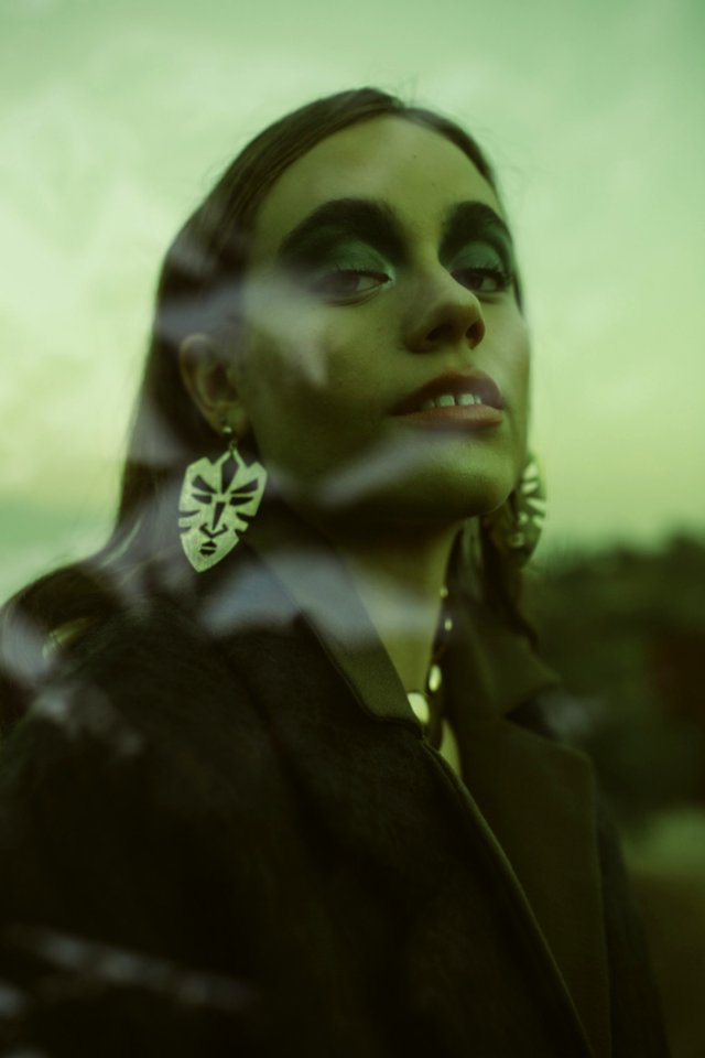 Woman Wearing Black Coat And Silver Earrings
