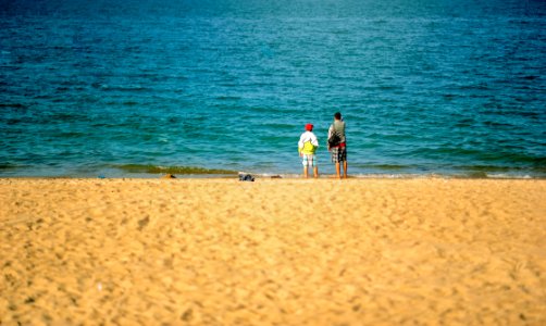 Two Persons Standing Near Beach photo