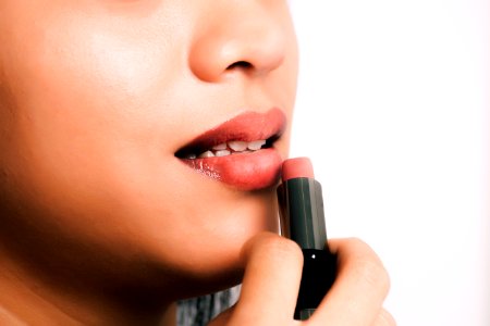 Woman Using Pink Lipstick photo