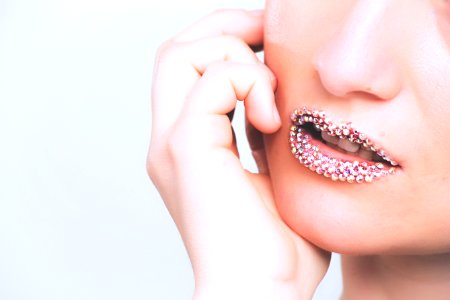 Woman With Gray Beaded Lipstick Close-up Photography photo