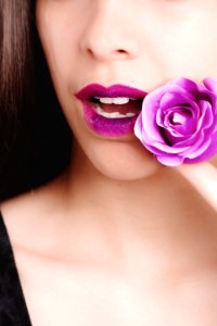 Woman Wearing Black Top Holding Purple Rose Flower photo