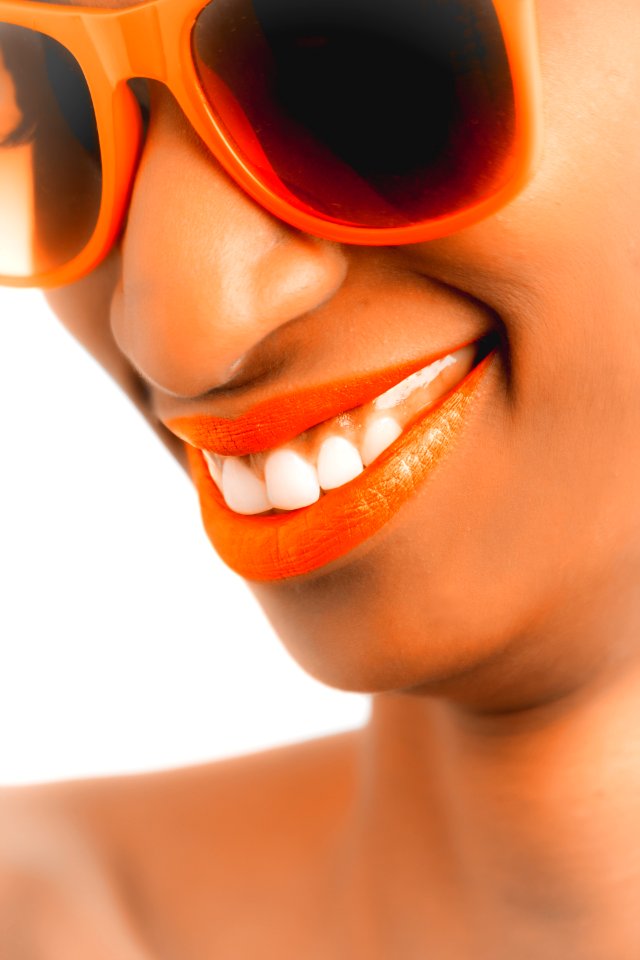 Woman Wearing Orange Frame Sunglasses And Orange Lipstick