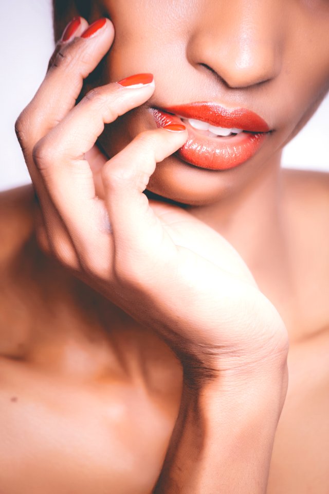 Woman With Orange Lipstick And Manicure Taking Selfie