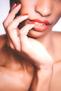Woman With Orange Lipstick And Manicure Taking Selfie