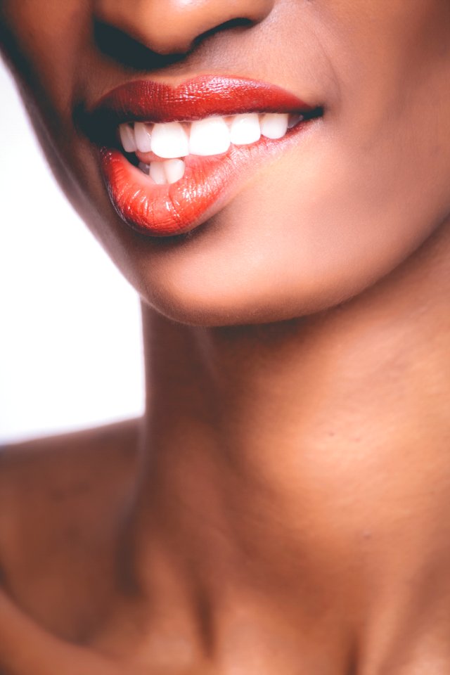 Photo Of Person Biting Its Own Red Lips