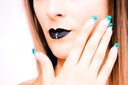 Woman With Black Lipstick And Teal Nail Polish photo