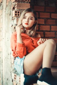 Woman Sitting On Concrete Ground photo