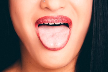 Woman With Wide Open Mouth And Tongue Out photo