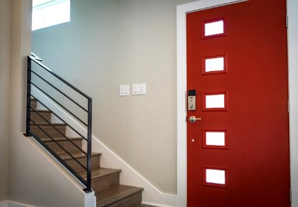 Red Wooden Door Beside Stairs photo